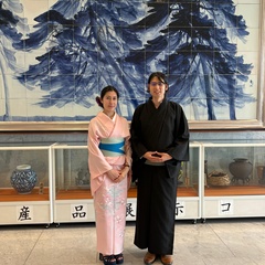 Dr. Ryuhei Sato  and Dr. Maélie Caussé wearing traditional Japanese clothing stand in front of a museum-style display.